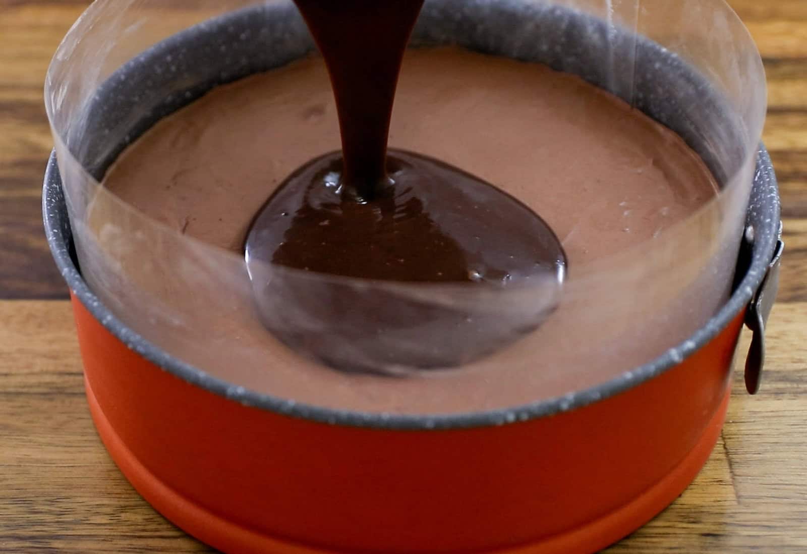 chocolate ganache poured on a chocolate cheesecake