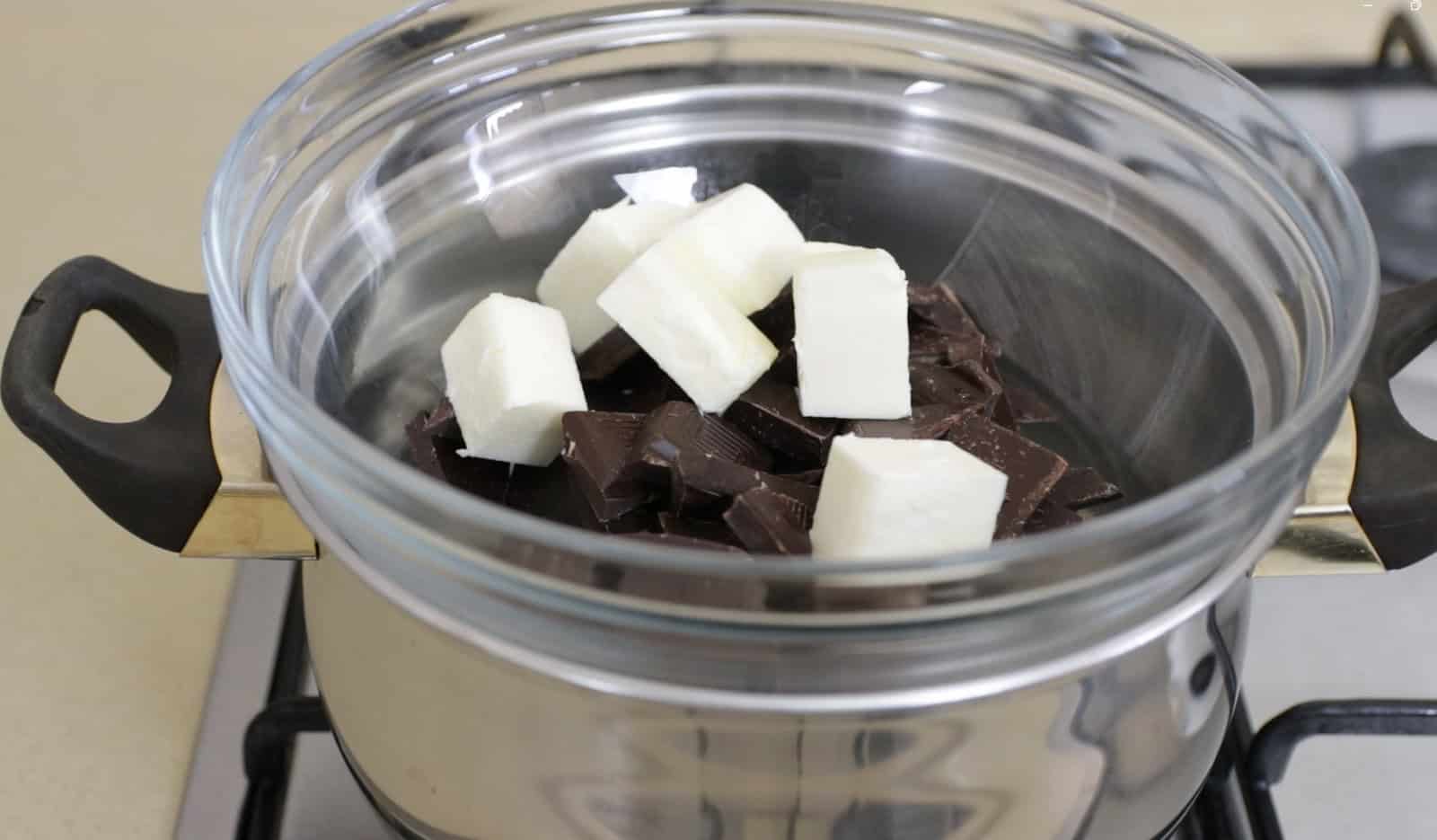 Over a double boiler, melt dark chocolate and butter until smooth, then mix in milk, vanilla, and optional coffee or liquor