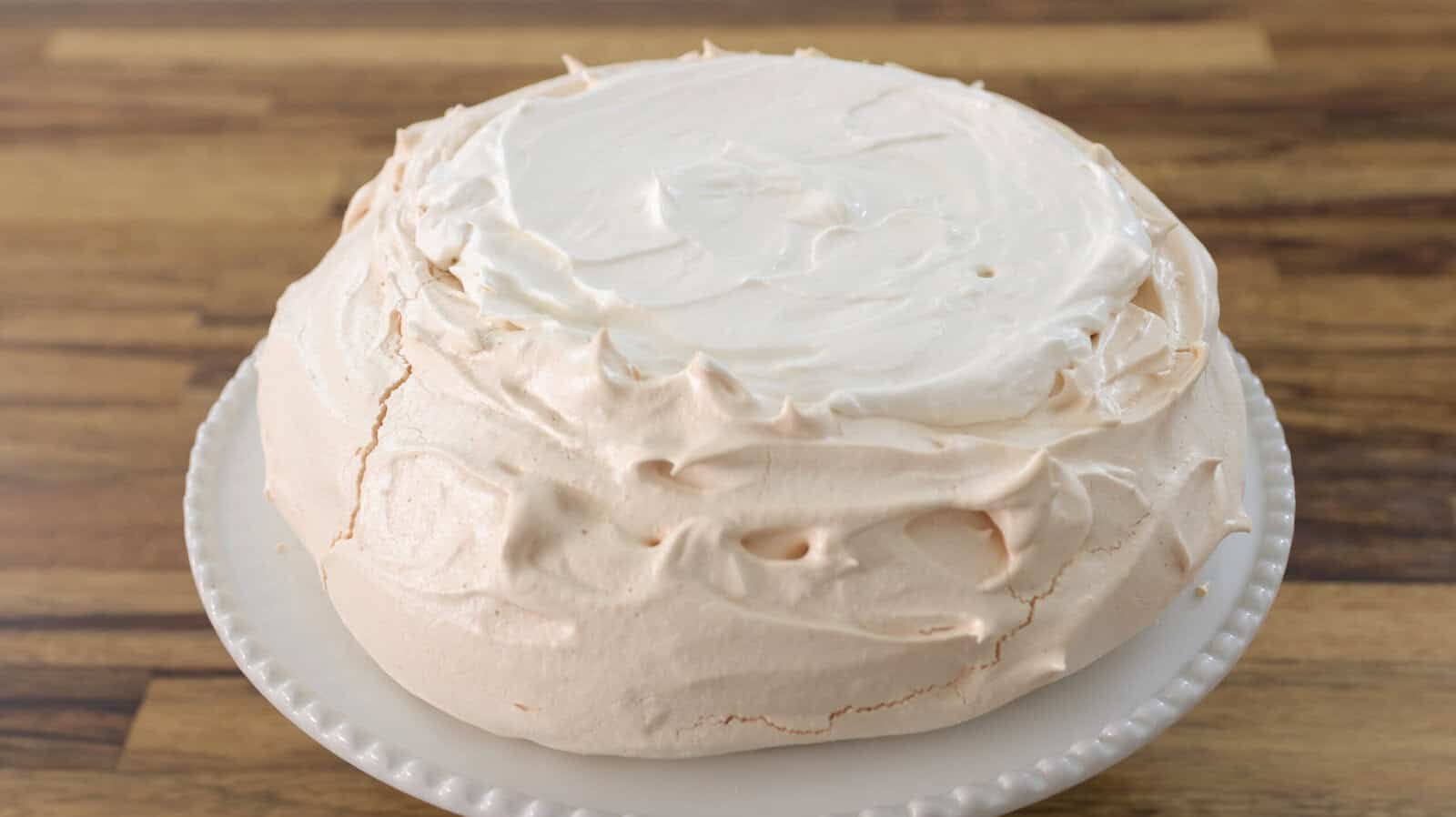 Whip up the cream with powdered sugar and decorate the pavlova