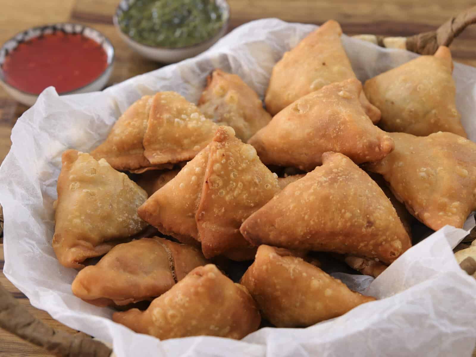 a batch of samosas in a basket 