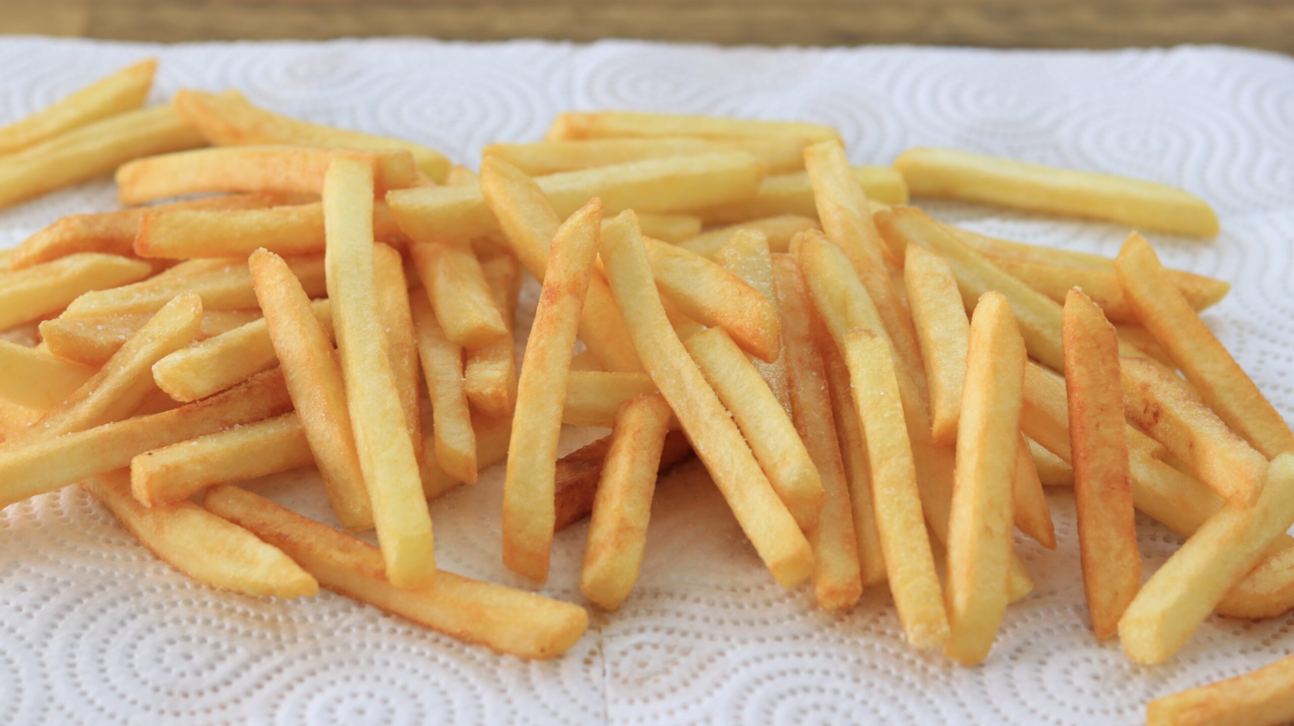 potatao fries laying on a paper towel