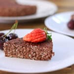 3-ingredient chocolate oatmeal cake topped with fresh strawberries and cherries