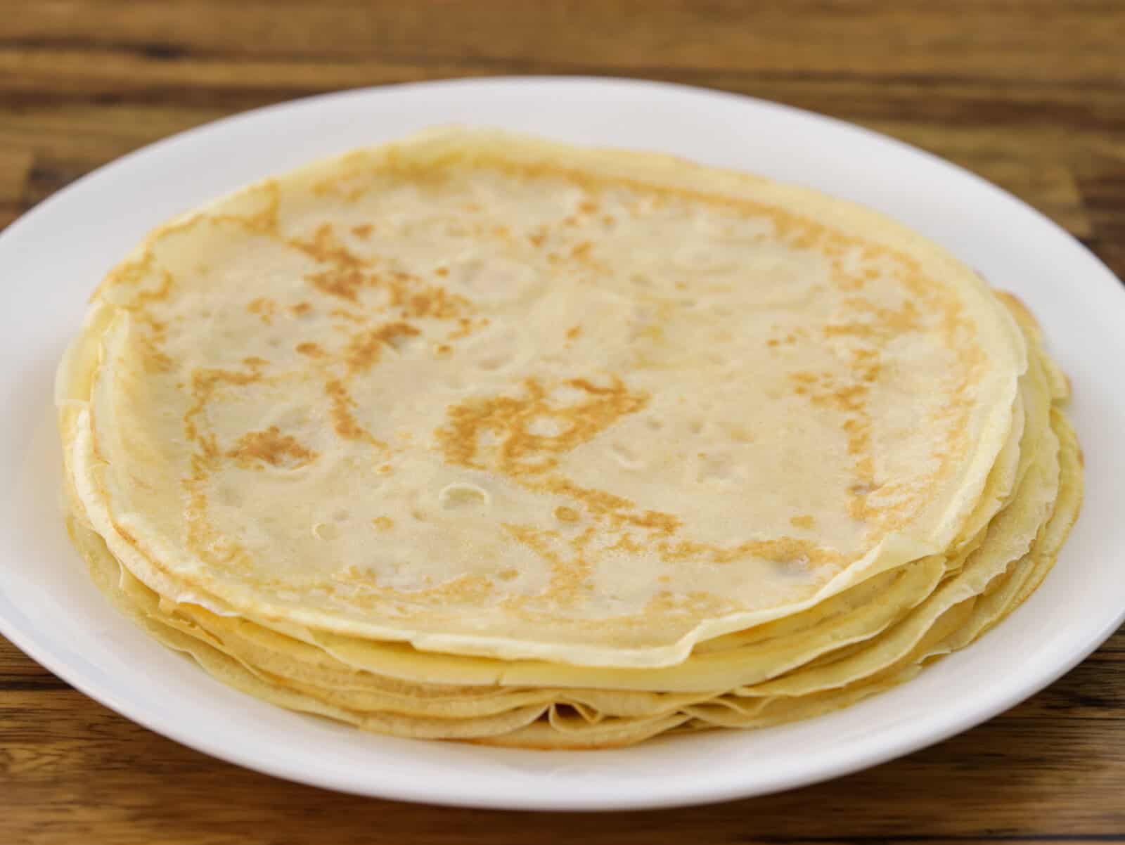 A plate with several thin sweet French crepes