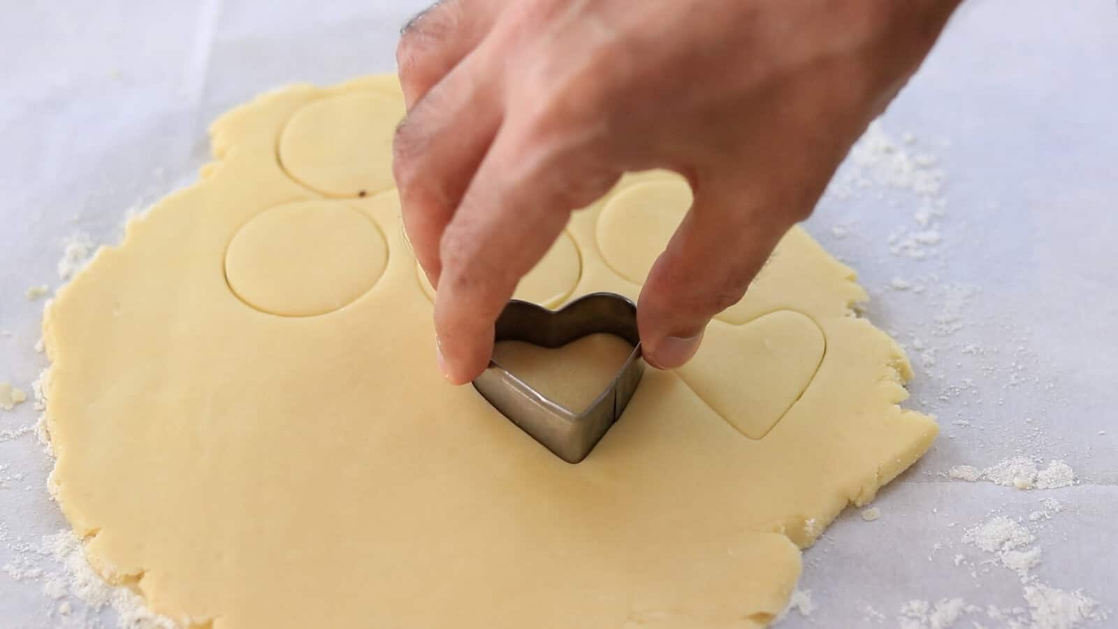 cutting cookie dough into hart shape