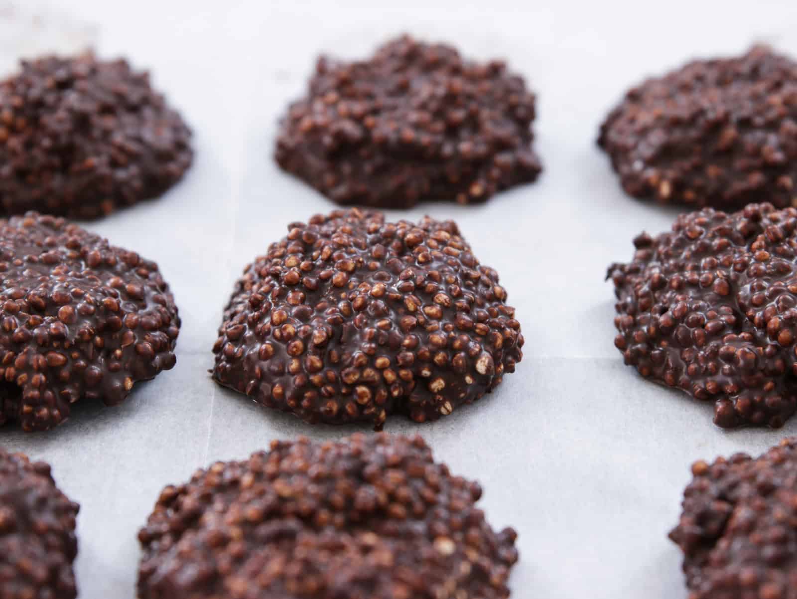 chocolate quinoa crips on a white parchment paper