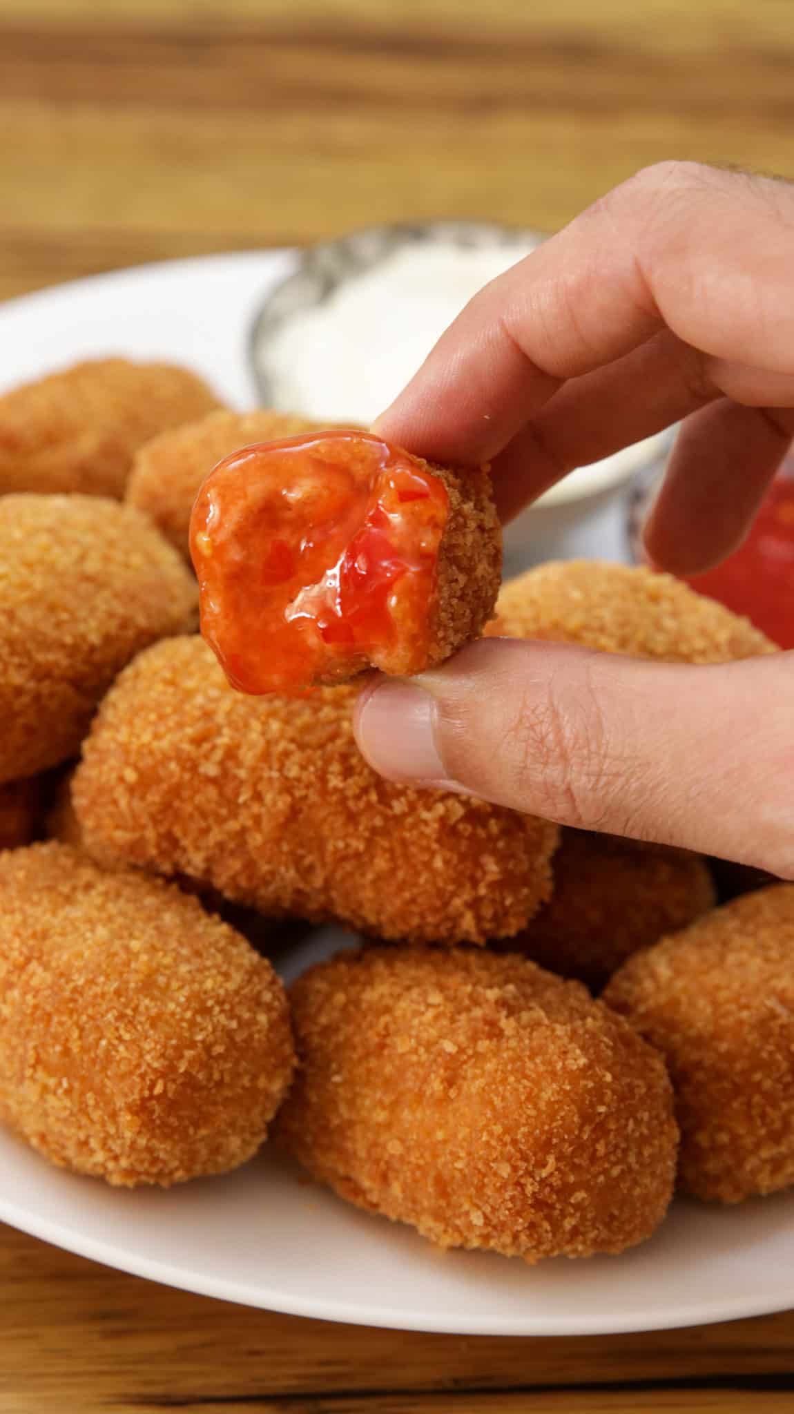 homemade chicken nuggets dipped in ketchup