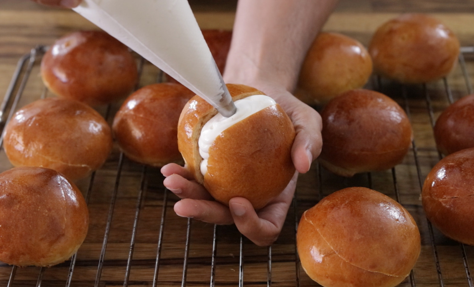 piping cream into a bun