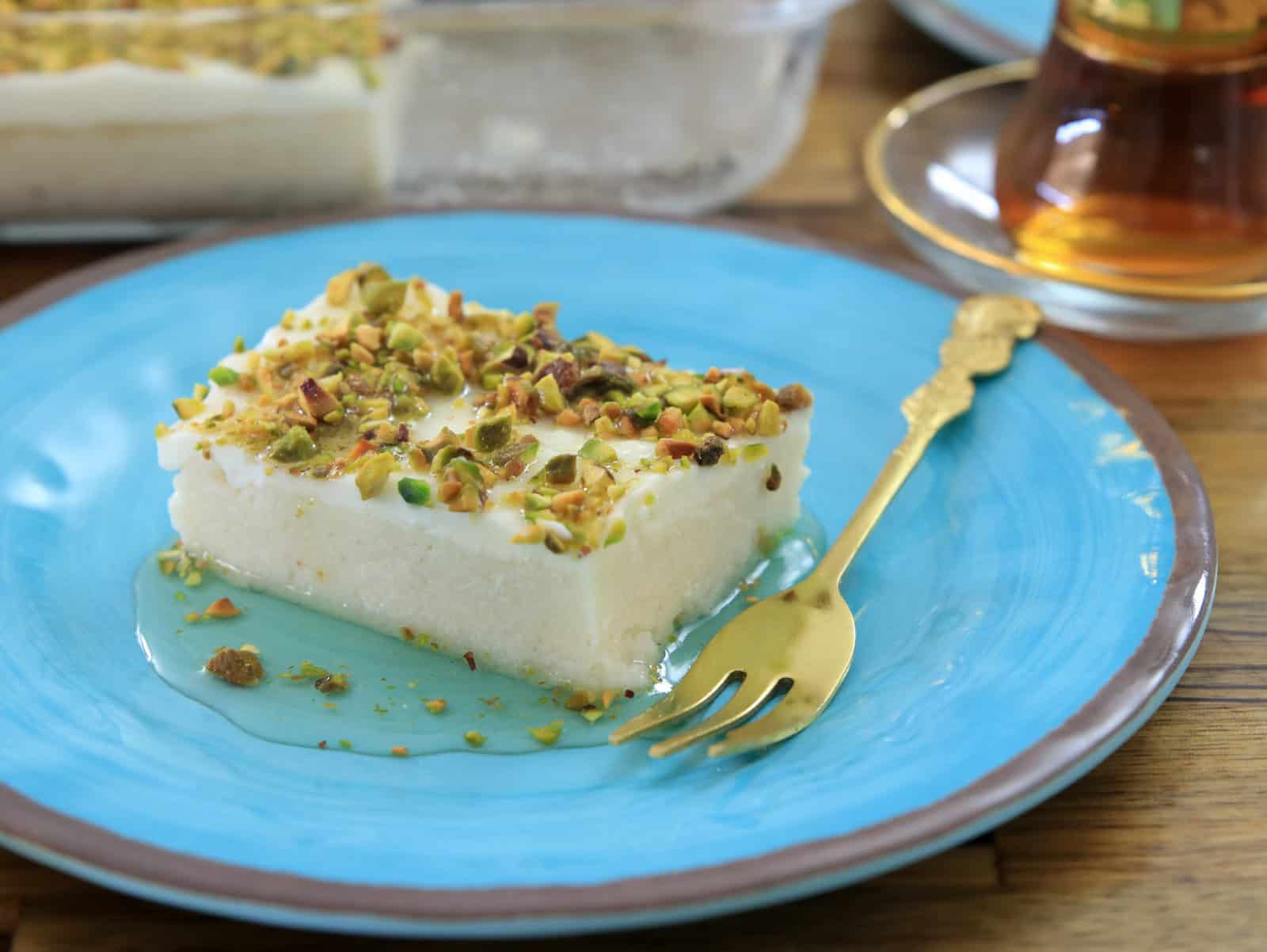 a piece of Lebanese night dessert topped with pistachios and drizzled with a simple syrup