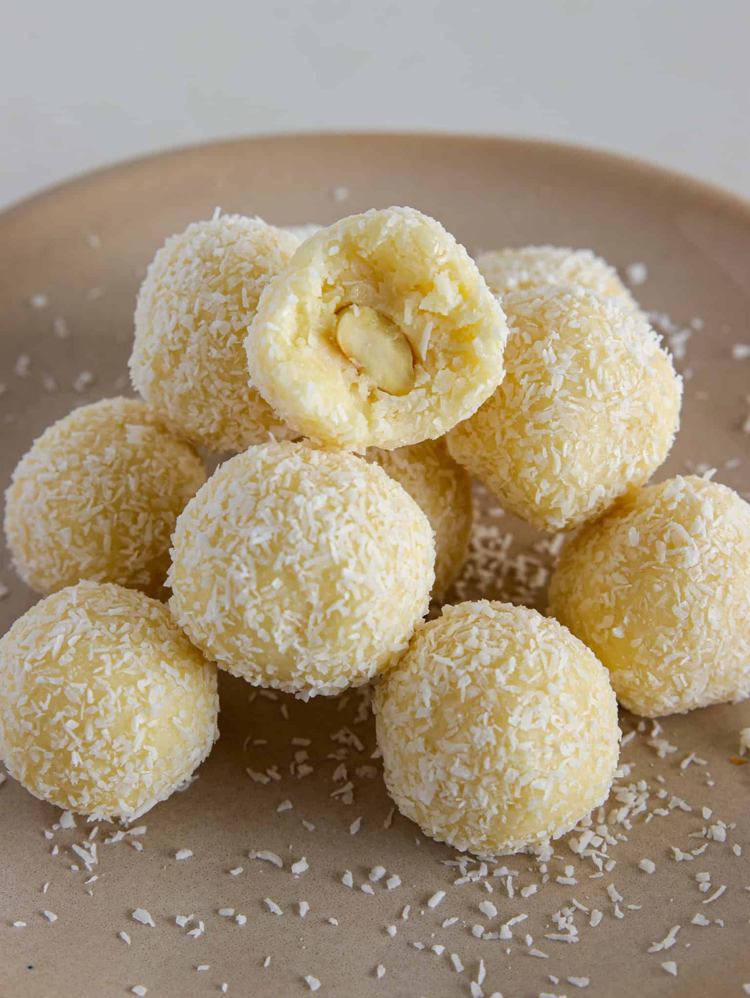 Homemade Raffaello Balls topped with shredded coconut flakes