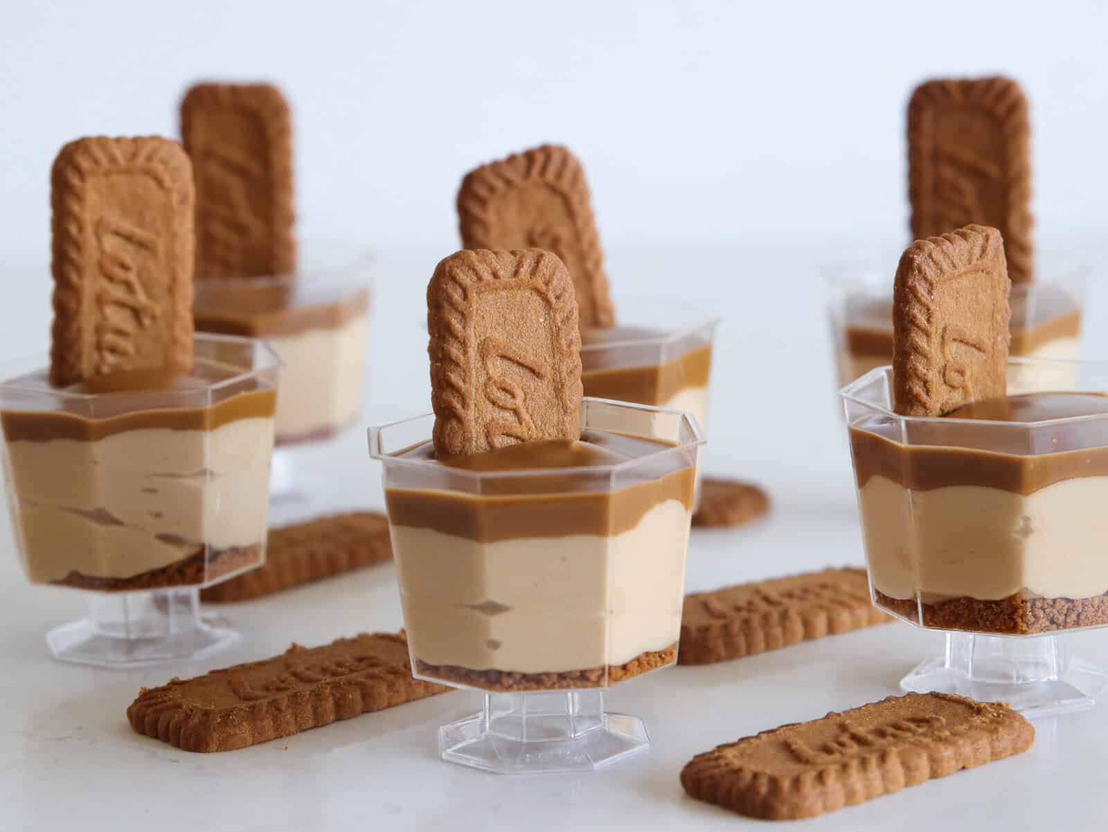 six glasses of  Lotus Biscoff Mousse topped with Biscoff cookies