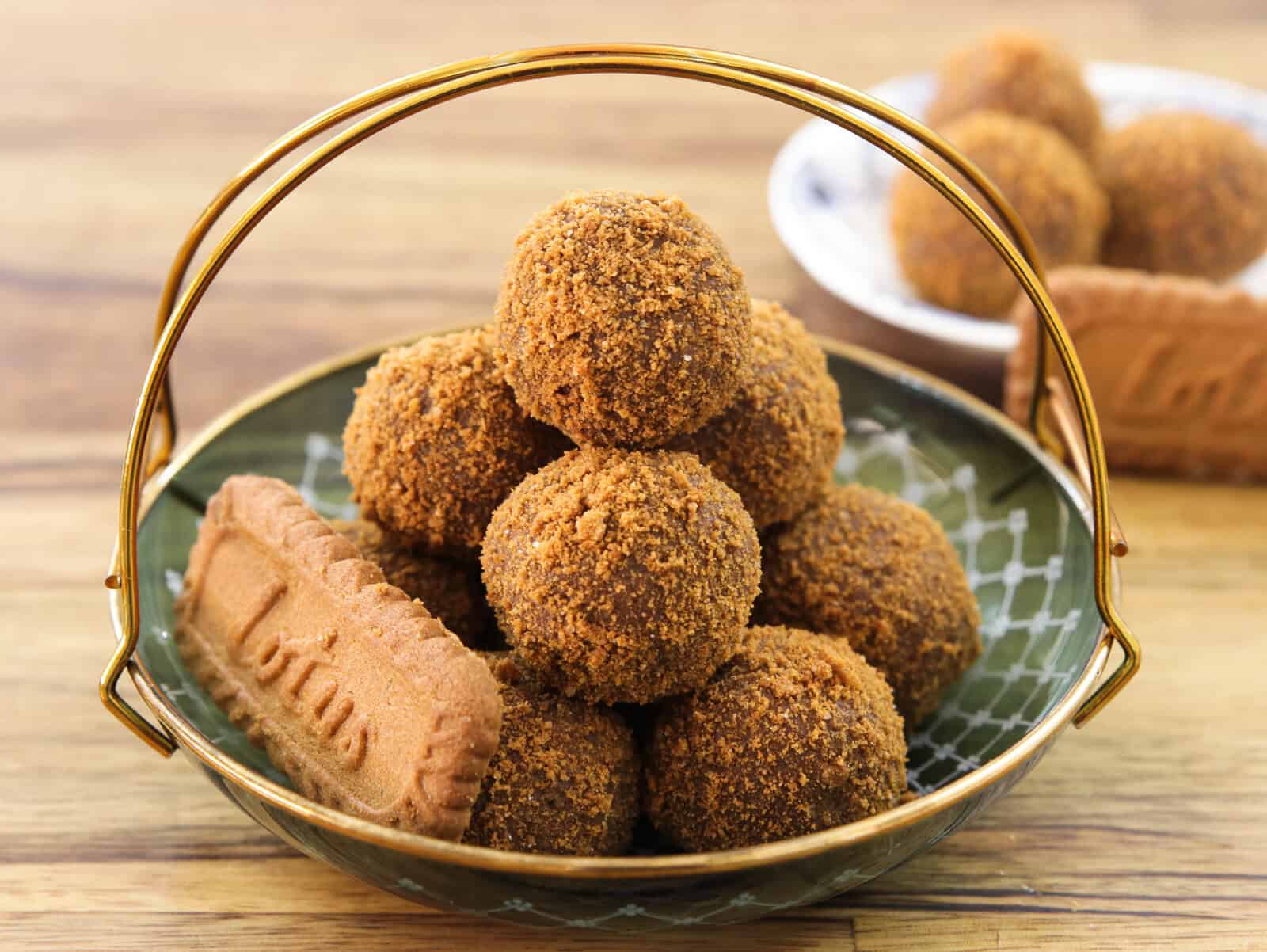 several lotus Biscoff truffles in a small plate with a single bisoff cookie