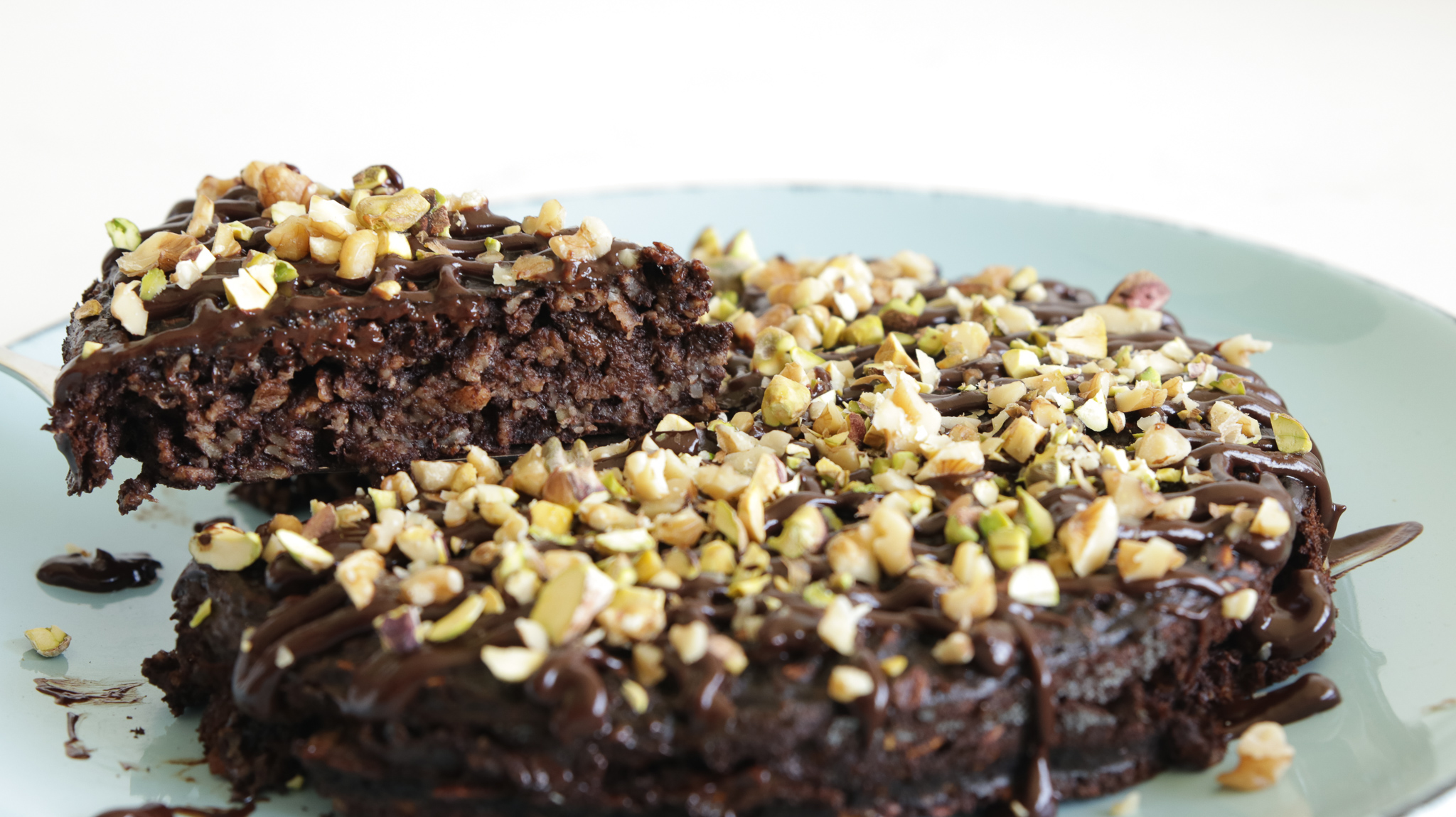 a slice of chocolate banana oatmeal cake lifted from the cake stand