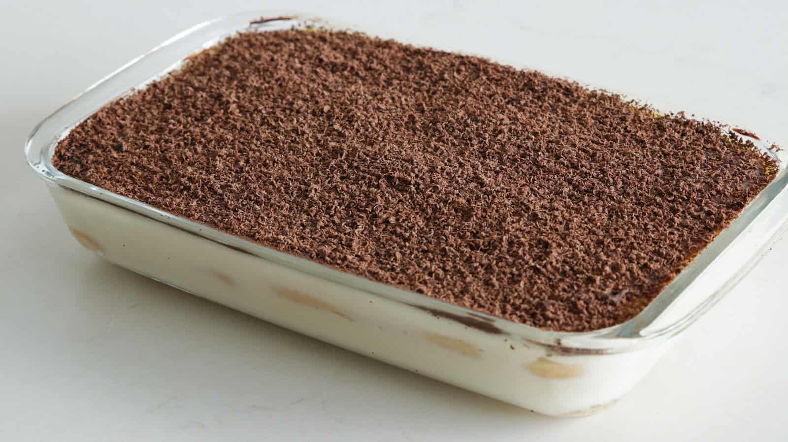 bid rectangle dish of Brazilian pave dessert topped with chocolate shavibgs