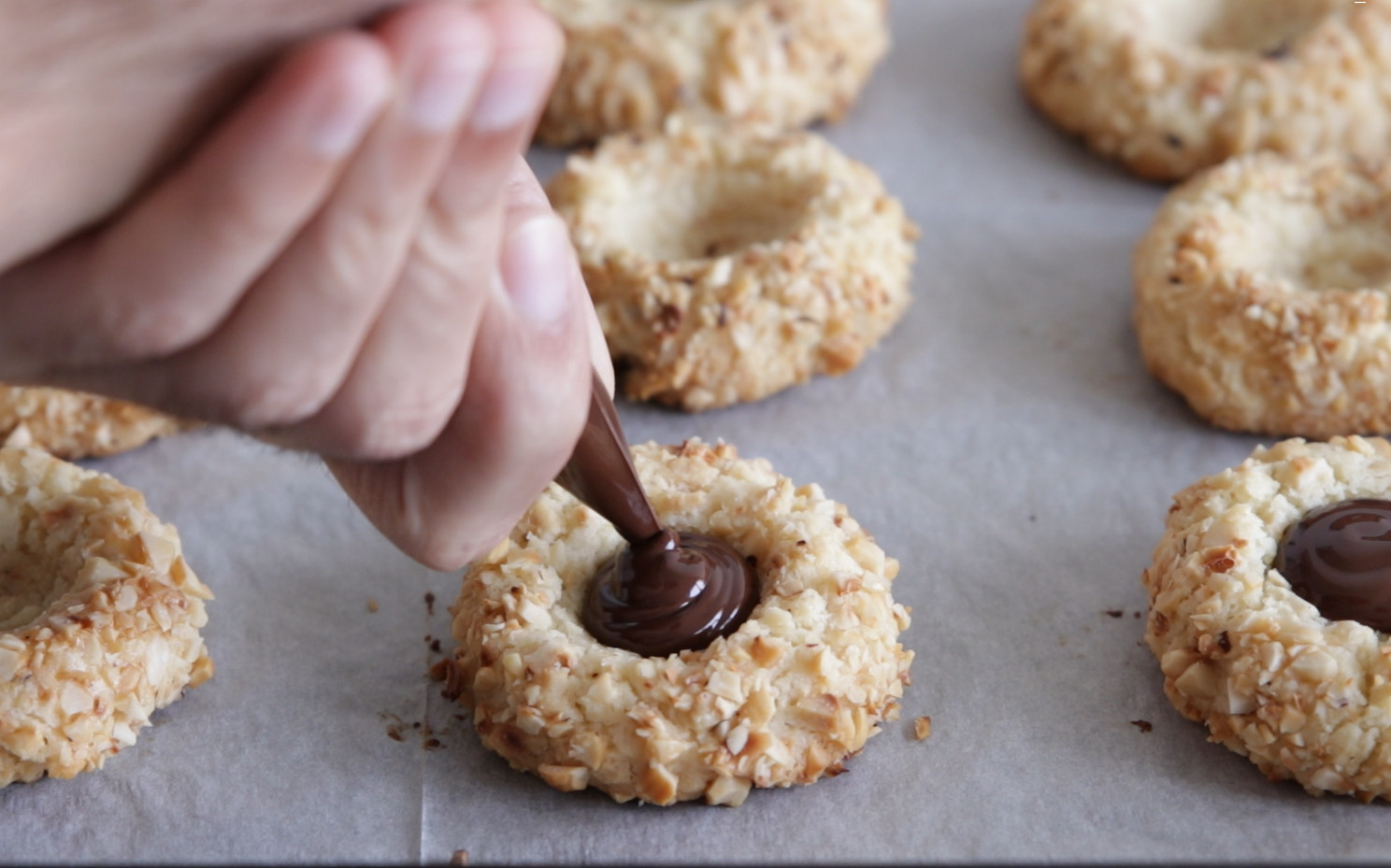 Melt chocolate, fill the thumbprints, and let them cool