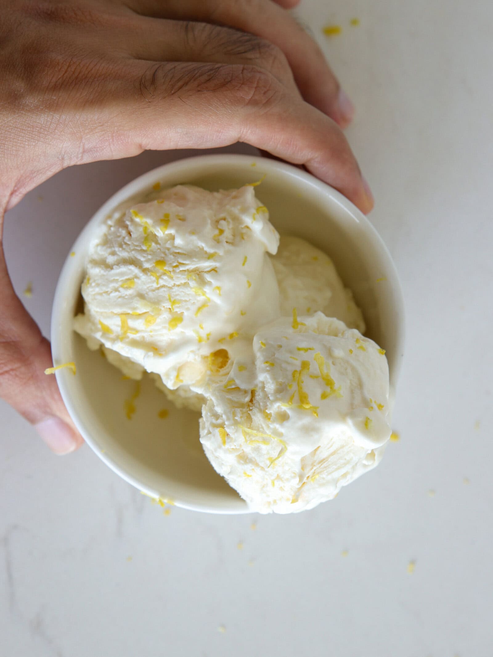 lemon ice cream in a bowl served lemon zest