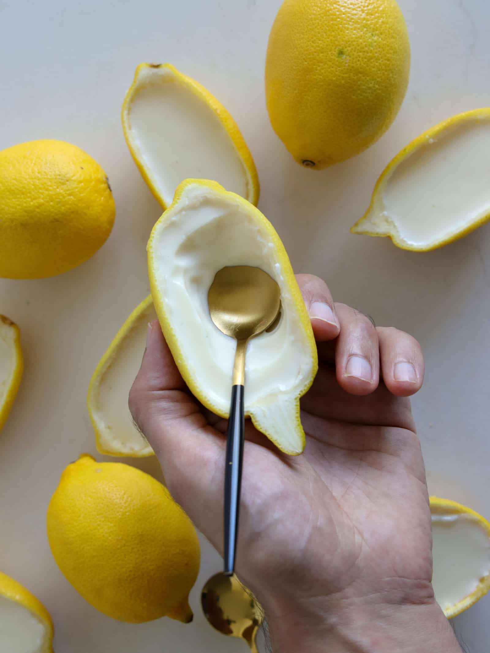 a hand holding creamy lemon posset