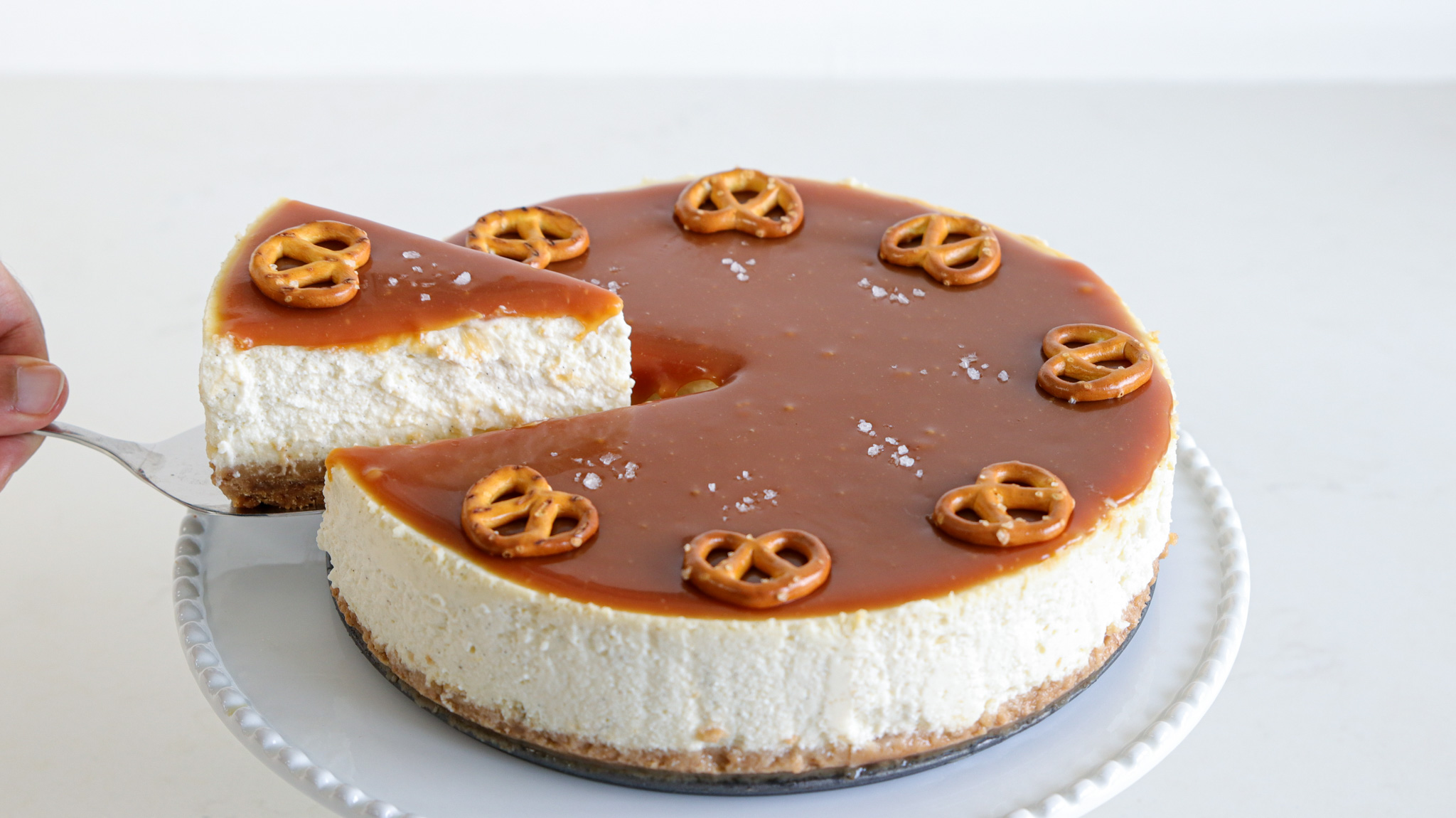 crea,y and rich salted caramel cheesecake with mini pretzel topping