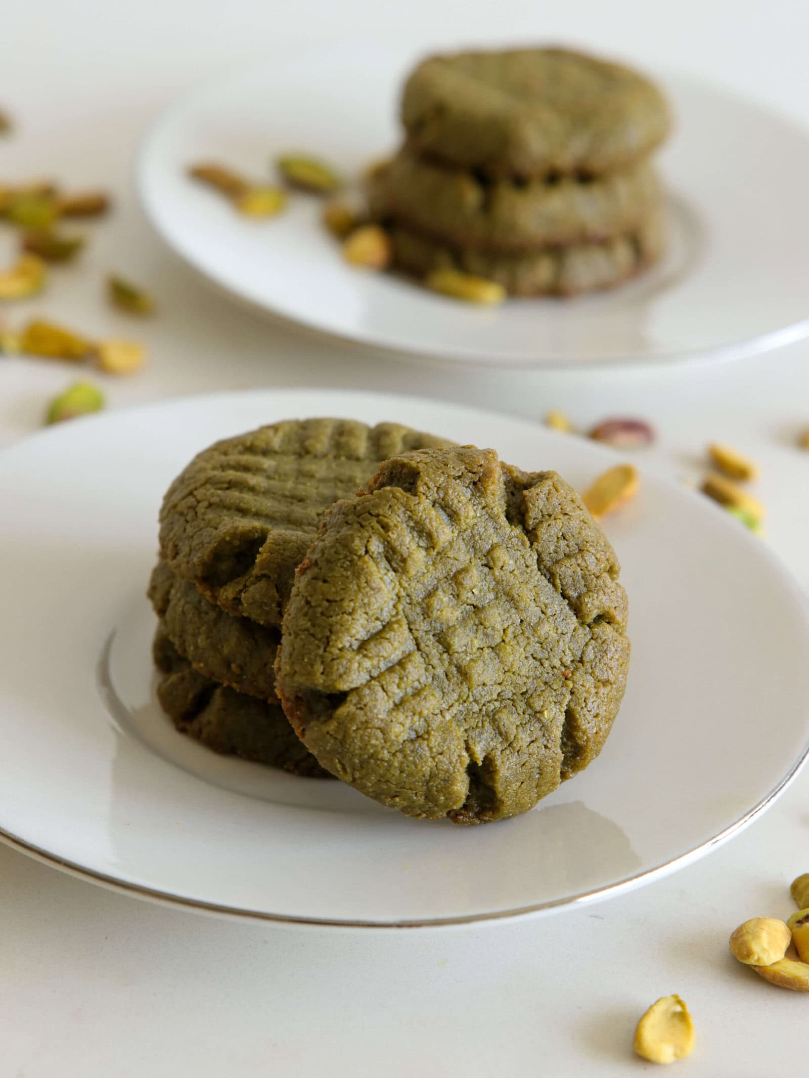 green homemade pistachio cookies on a small white plate