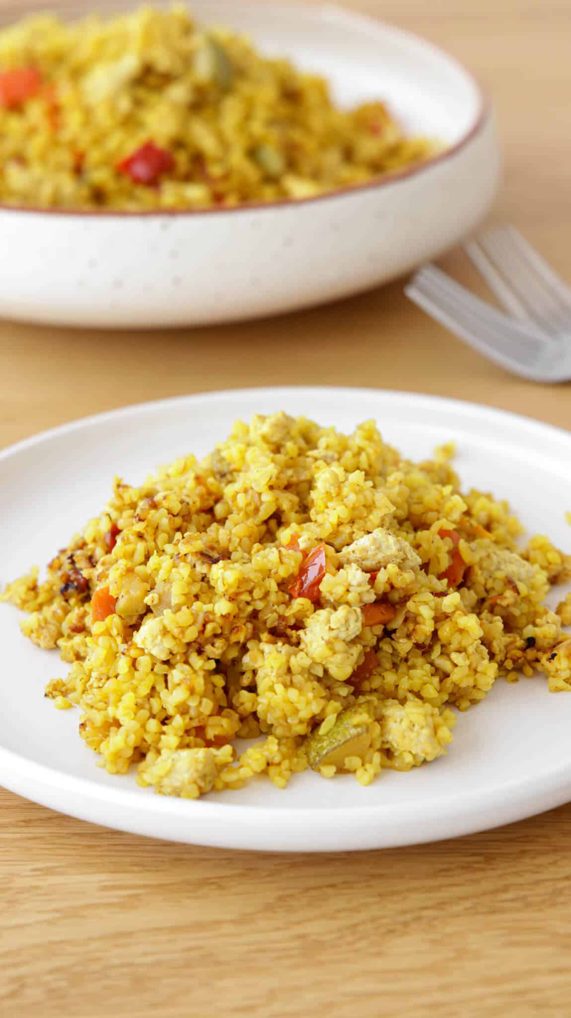 chicken bulgur and vegetables on a white plate