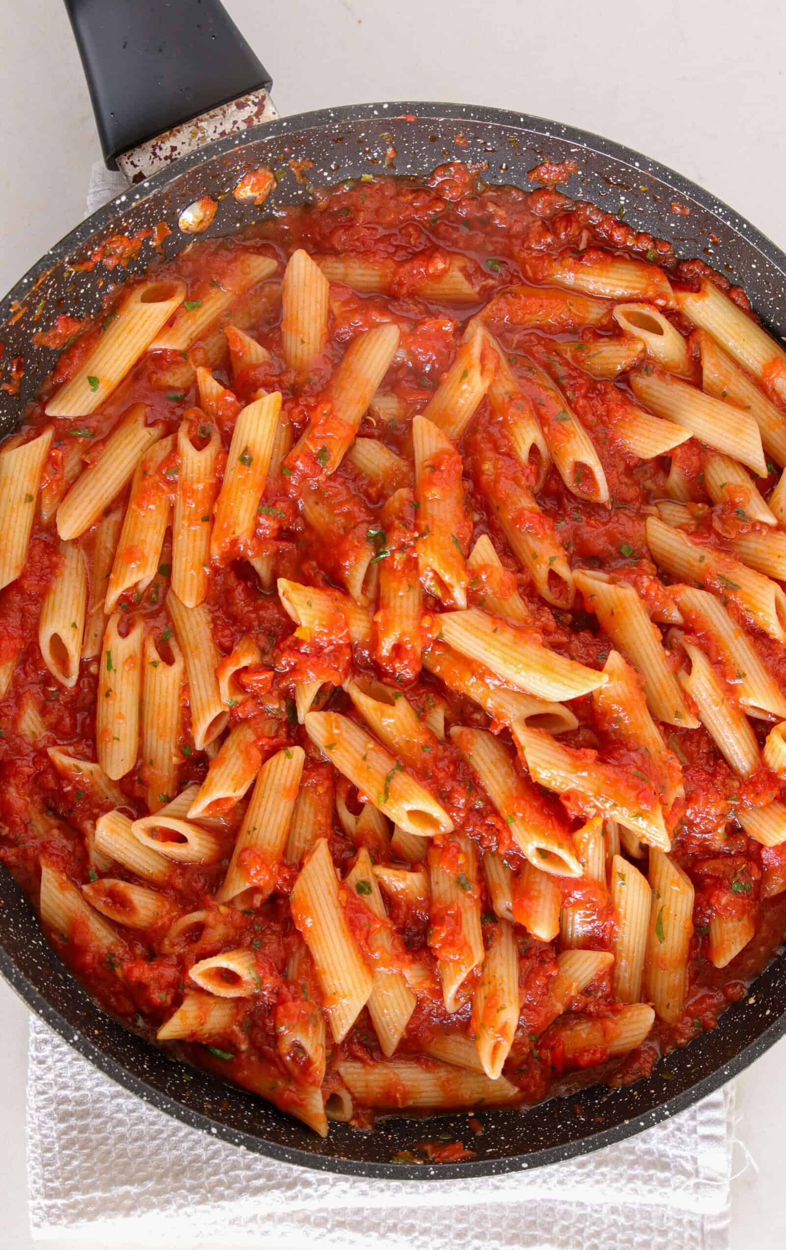 Penne all’Arrabbiata cooking in arrabbiata sauce