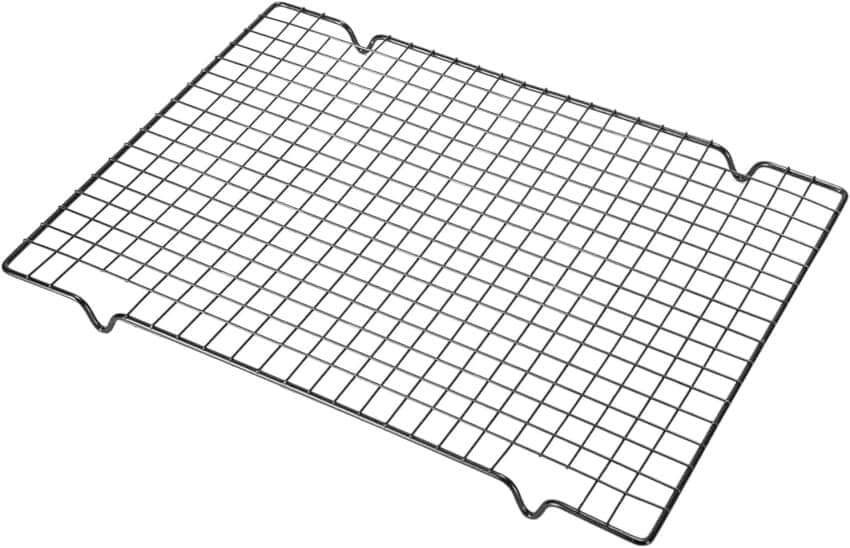 A rectangular metal cooling rack with a grid pattern and slight notches on the edges, designed for cooling baked goods. The rack has an elevated design to allow air circulation below.