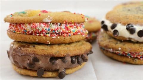 Two ice cream sandwiches are shown, each made with cookies as the outer layers. The left sandwich has chocolate chip cookies with chocolate ice cream and chocolate chips, while the right sandwich features cookies with vanilla ice cream and rainbow sprinkles.