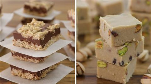 On the left, there are three oat and chocolate bars, stacked with parchment paper between each. On the right, there are small cubes of nougat, some containing visible nuts like pistachios, arranged in stacks. The treats are displayed on a wooden surface.