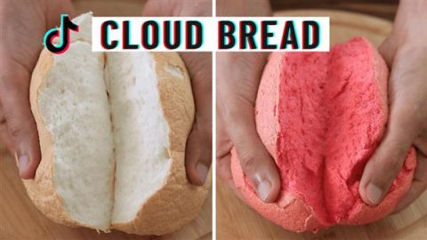 Two hands are shown tearing apart two pieces of cloud bread. The left piece is white and fluffy, while the right piece is pink and equally fluffy. The text "CLOUD BREAD" is prominently displayed at the top with a TikTok logo on the left.