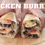 A close-up of two hands holding two halves of a chicken burrito on a wooden cutting board. The burrito contains rice, black beans, chicken, and vegetables. The text "CHICKEN BURRITO" appears prominently at the top of the image.