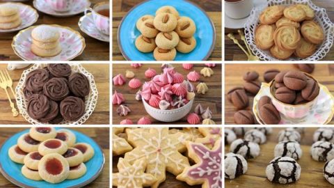 A collage of different types of cookies arranged on plates and cups, featuring powdered sugar cookies, ring-shaped cookies, vanilla cookies, chocolate cookies, meringue kisses, chocolate-filled cookies, thumbprint cookies with jam, snowflake-shaped cookies, and crinkle cookies.