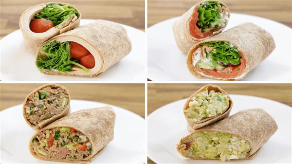 Image showing four different types of wraps on a wooden table. Each wrap is sliced in half to reveal the fillings. The wraps contain a variety of ingredients, including vegetables, greens, and proteins, all neatly presented on four separate plates.