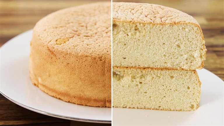 A light brown sponge cake is shown in two views: whole on the left and sliced in half on the right, revealing its soft, airy texture. It is placed on a white plate with a wooden table surface in the background.