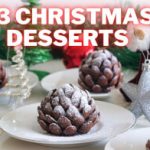 A festive scene featuring multiple plates of Christmas desserts resembling pinecones, dusted with powdered sugar. The background includes green decorative Christmas trees, ornaments, and a Santa Claus figure. Text at the top reads "43 Christmas Desserts.