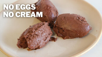 Three scoops of rich chocolate ice cream on a beige plate with text overlay saying "NO EGGS NO CREAM.