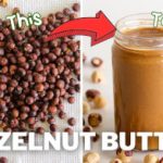 Image showing a transformation from raw hazelnuts to hazelnut butter. The left side of the image has raw hazelnuts with the text "From This," and the right side features a jar of smooth hazelnut butter with the text "To This." The caption reads "HAZELNUT BUTTER.