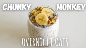 A glass filled with chunky monkey overnight oats, topped with banana slices, walnuts, and chocolate chips. Text on the image reads "CHUNKY MONKEY" at the top and "OVERNIGHT OATS" at the bottom.