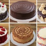 A grid of six different round cakes displayed on white cake stands. The cakes are decorated with various toppings: whipped cream and cherries, smooth chocolate glaze, piped caramel swirls with a slice cut, red velvet hearts, caramel with nuts, and colorful sprinkles.