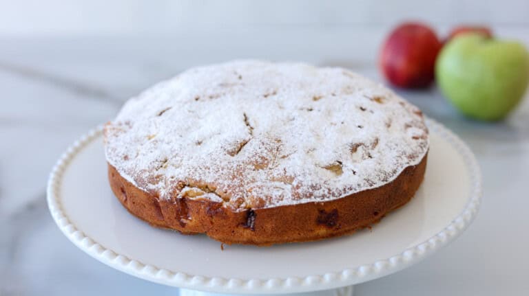 homemade simple apple cake recipe with powdered sugar on top