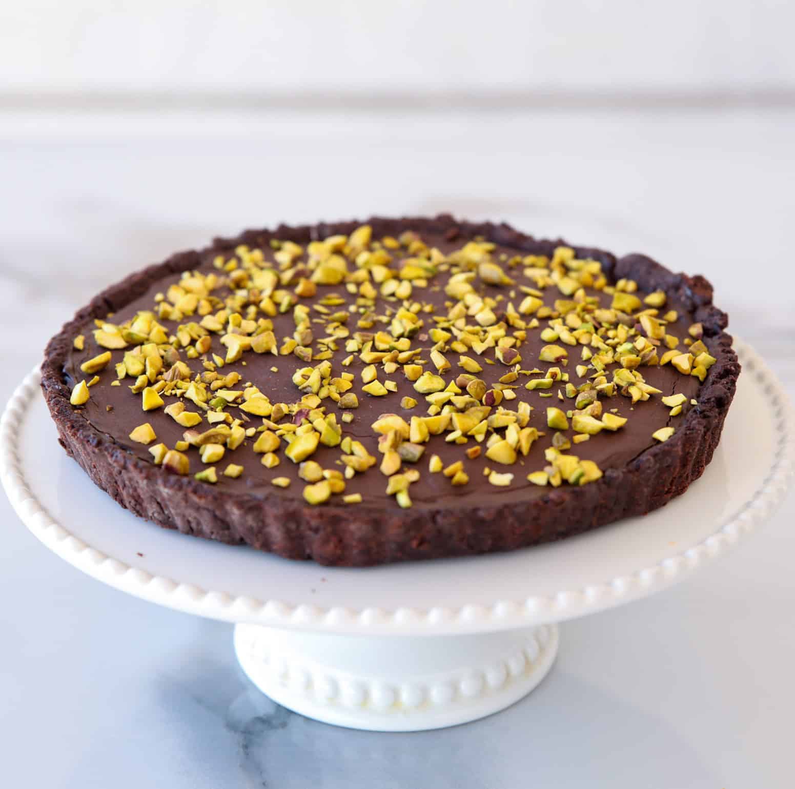 Dubai chocolate tart decorated with chopped pistachios