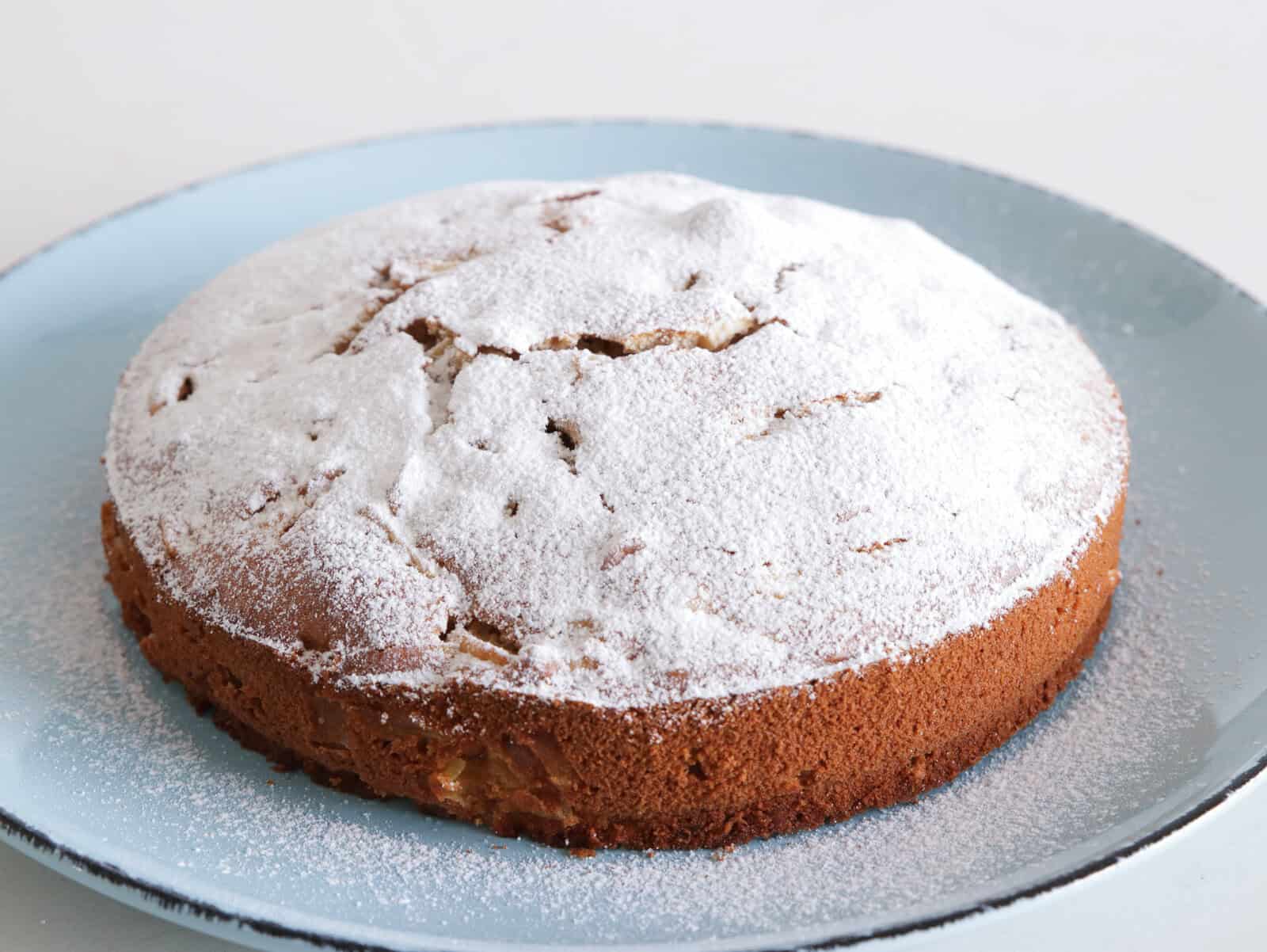 homemade apple cake topped with icing sugar