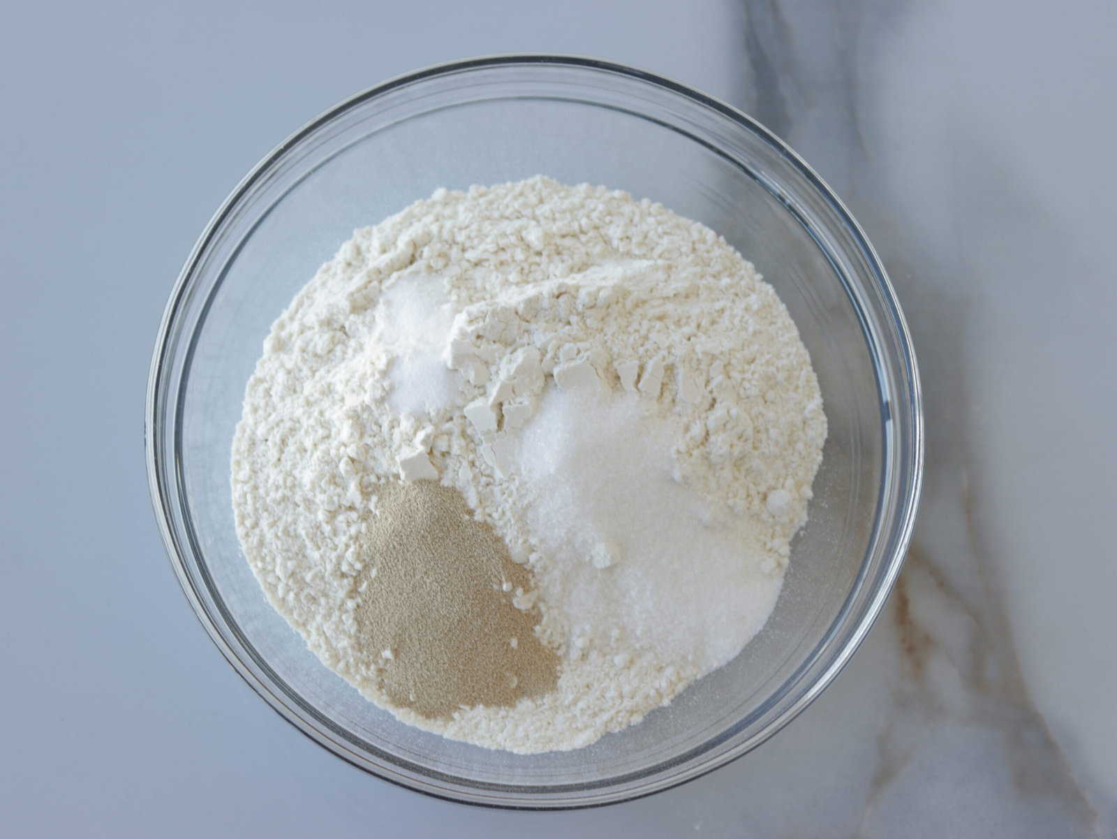 flour, sugar and yeast in a bowl