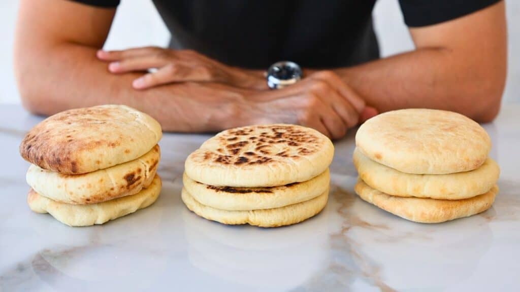 3 homemade pita breads on a counter