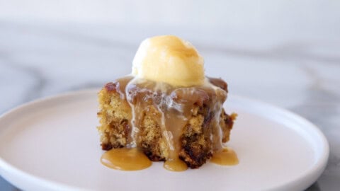 sticky toffee pudding with a drizzle of caramel sauce and vanilla ice cream