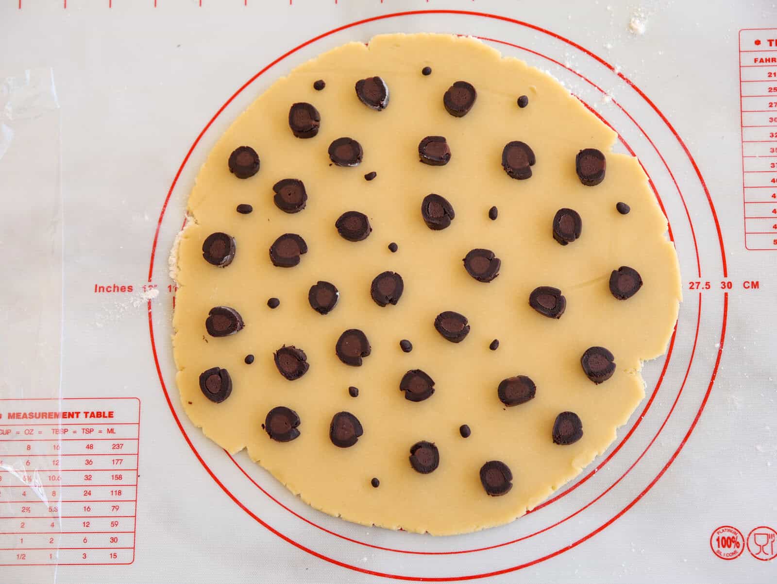 Place the prepared spots randomly over the plain dough