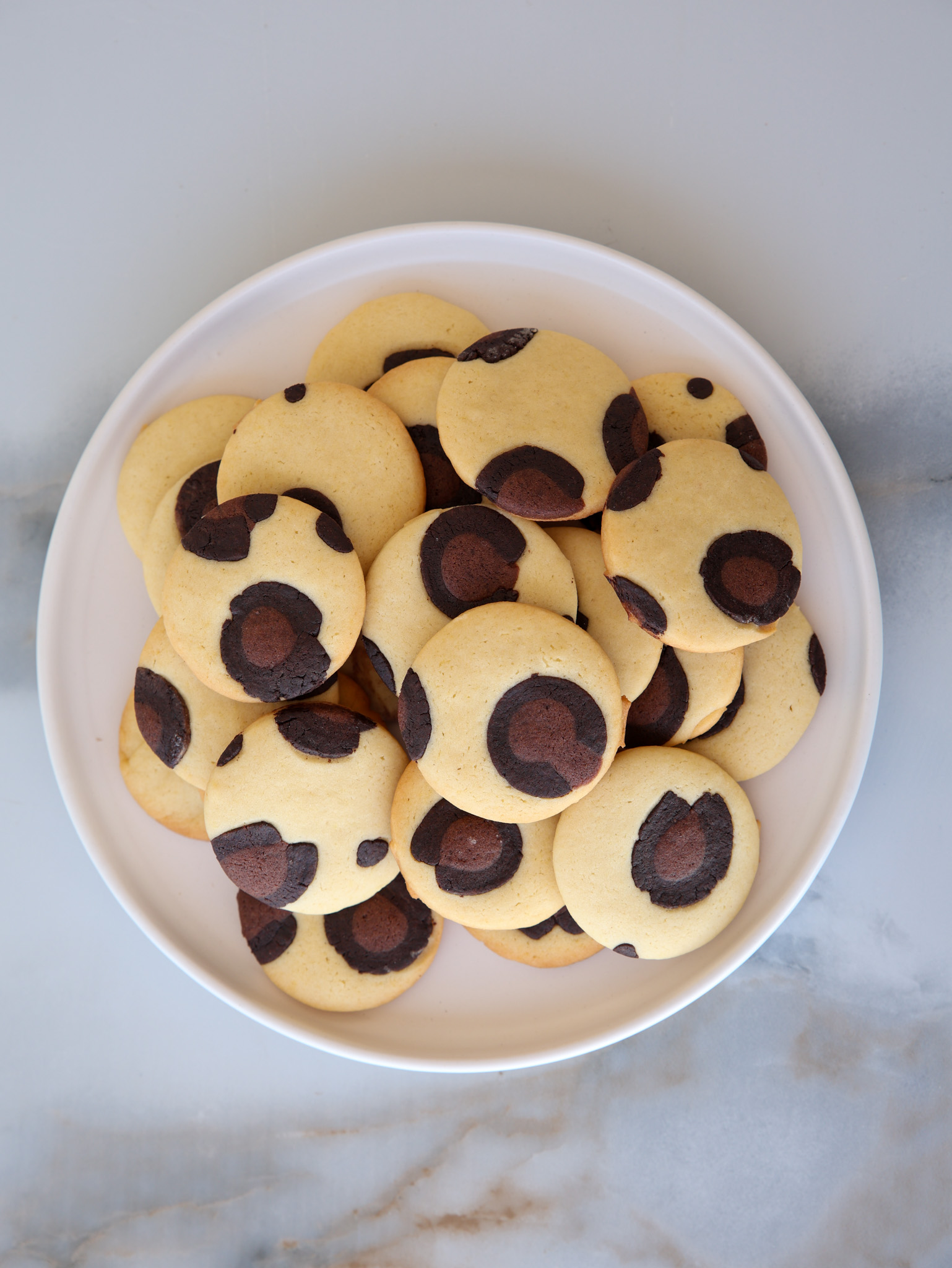 leopard print cookies on a white plate