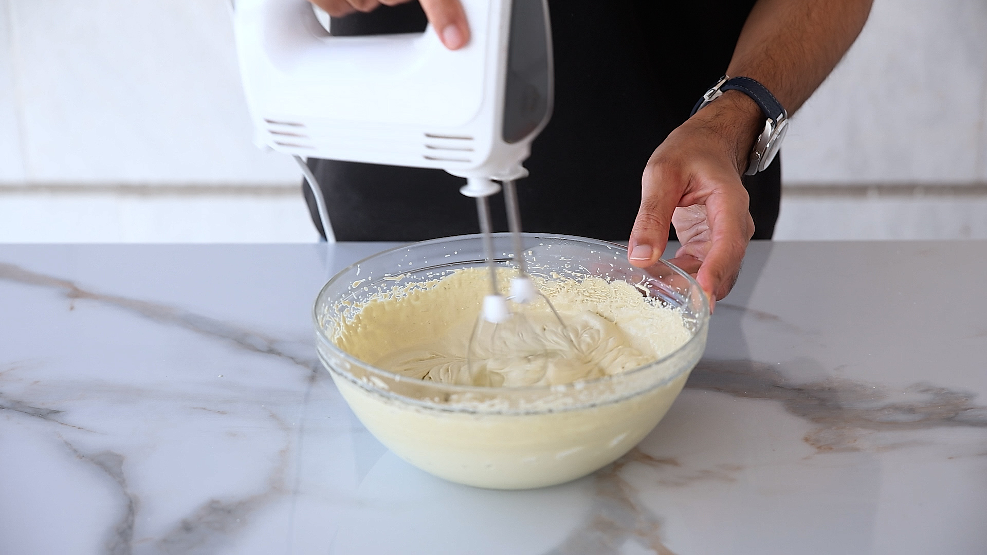 whipping heavy cream and pistachio paste to stiff peaks