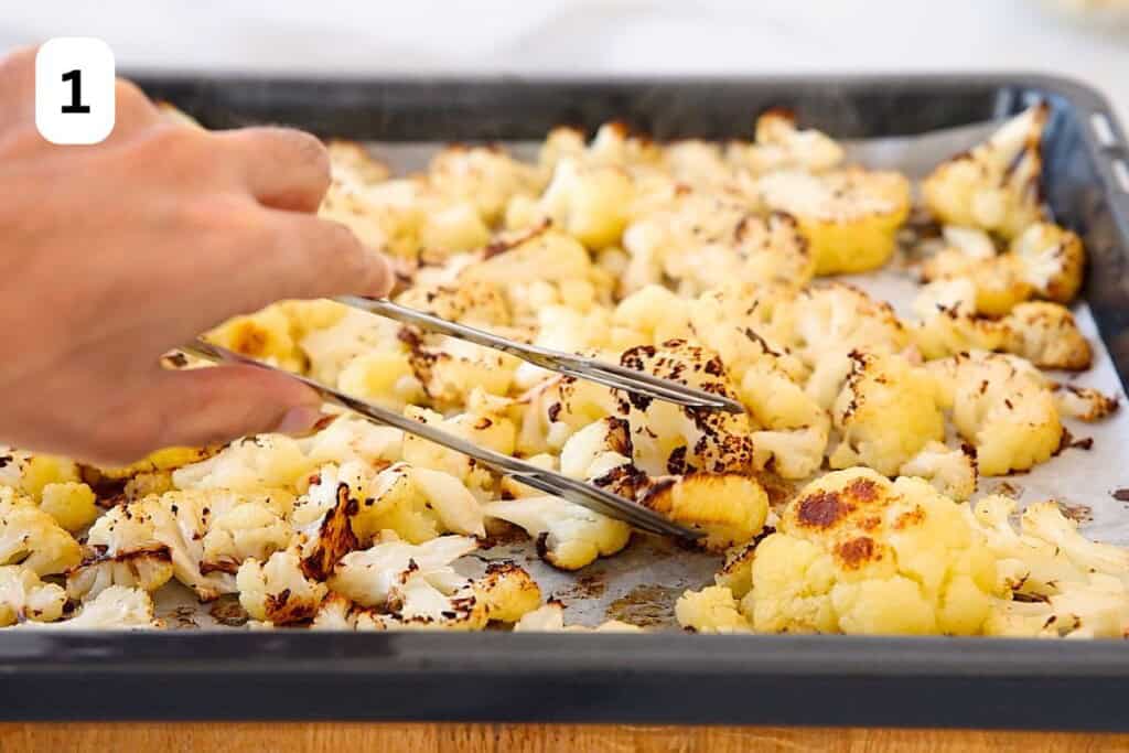 roasted cauliflower florets in a baking tray.