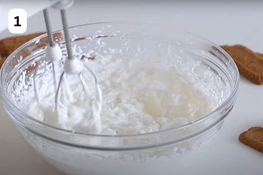 mixer whipping cream in a bowl.