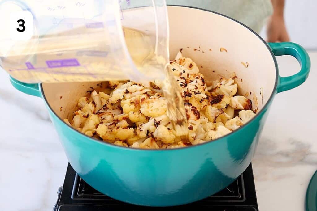 stock is added to the pot with cauliflower.