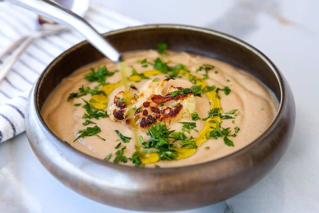 creamy cauliflower soup in a bowl.